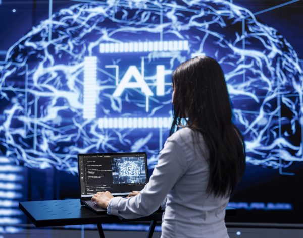 Programmer analyzing complex AI brain models on laptop, running simulations. Female employee using machine learning software on notebook device to develop artificial intelligence technology