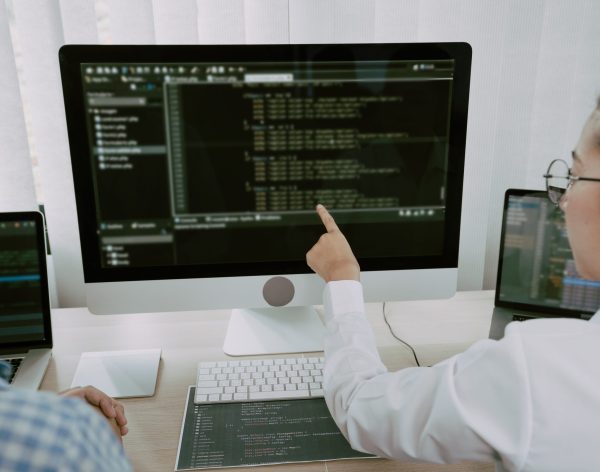 Two asian team working development of programming and encryption technology website design programmers on desk in office.